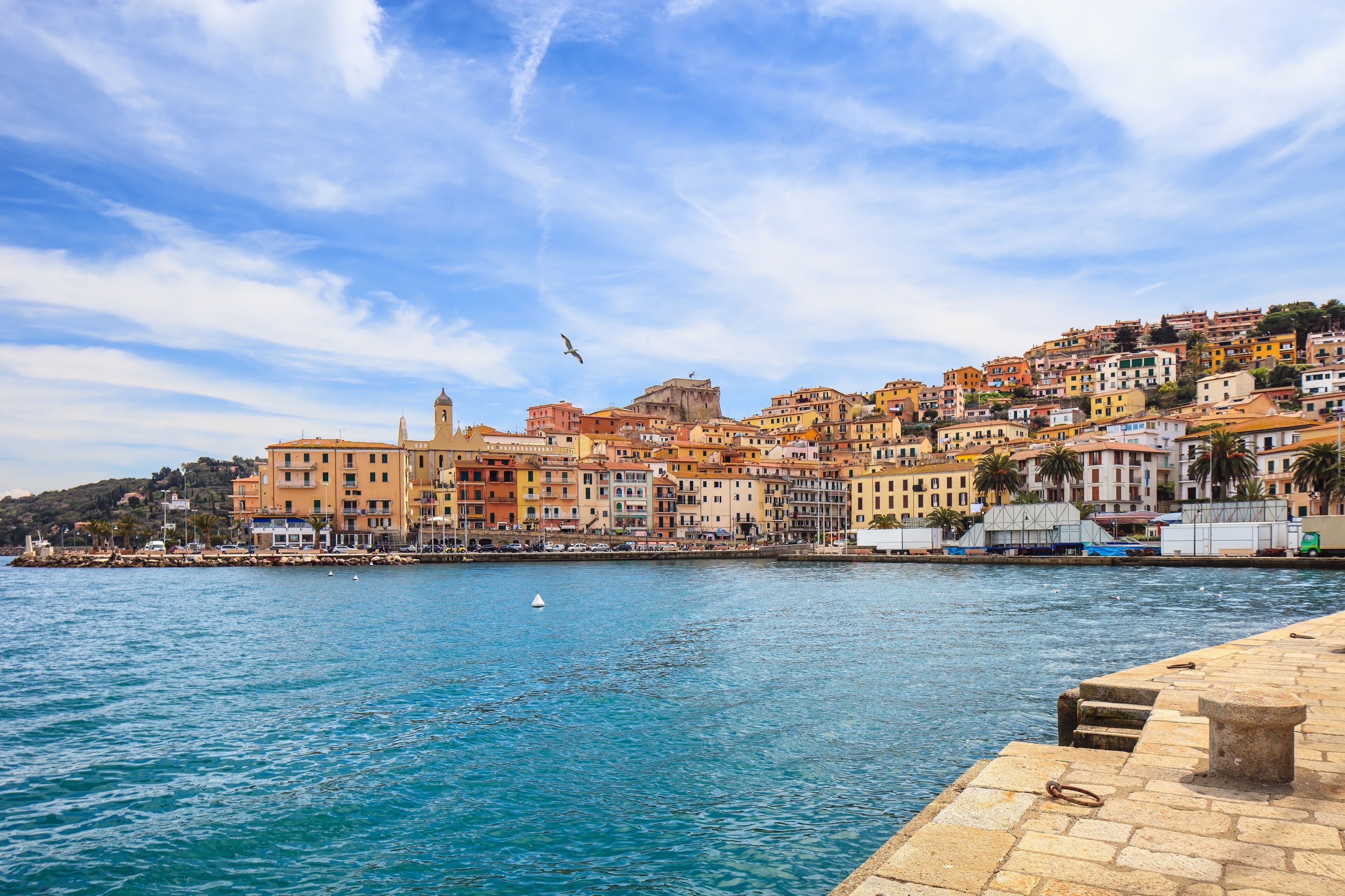 Porto Santo Stefano harbor seafront, bolllard and village skyline., italian travel destination. Monte Argentario, Tuscany, Italy., Shutterstock ID 134752493, Purchase Order: -