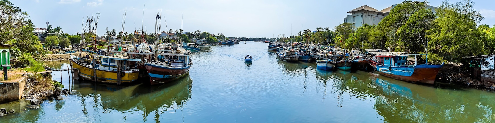 A panorama view of fishing vessels across the entrance to the lagoon in Negombo, Sri Lanka