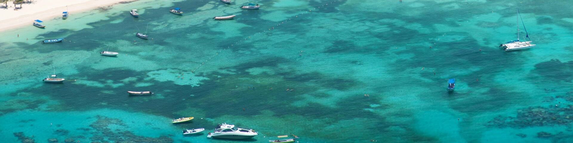 Riviera Maya which includes boating, a sandy beach and tropical scenes