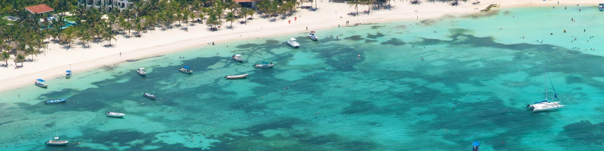 Riviera Maya which includes boating, a sandy beach and tropical scenes