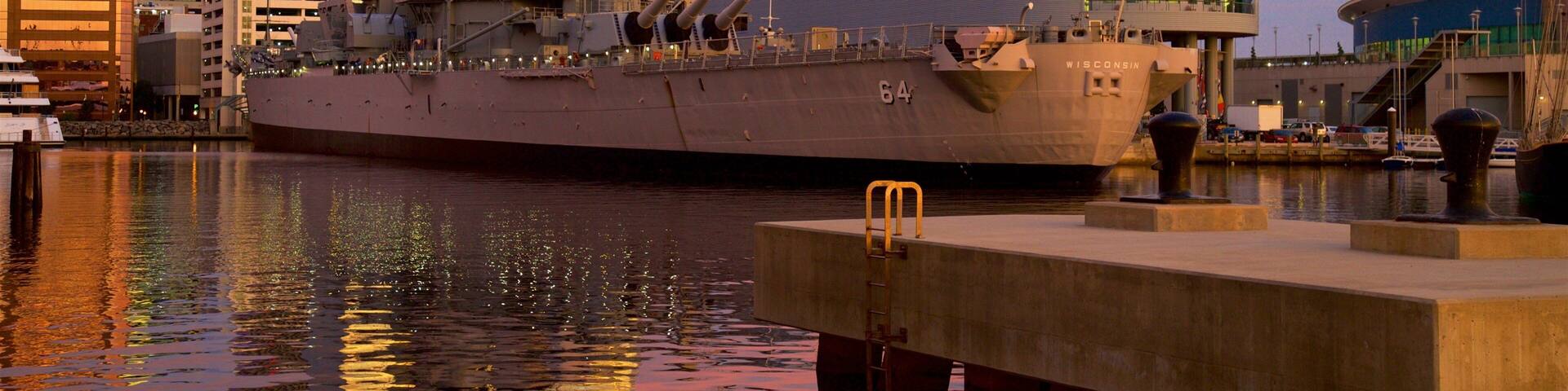 Norfolk - Virginia Beach which includes a sunset, military items and a bay or harbor