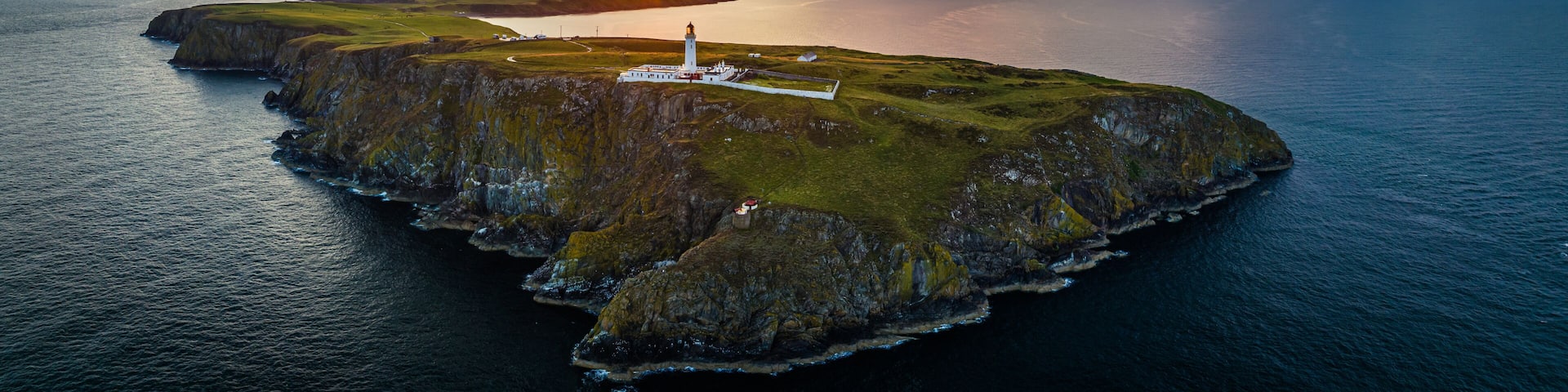 Sunset over Mull of Galloway Lighthouse from a drone, Mainland Scotland, UK