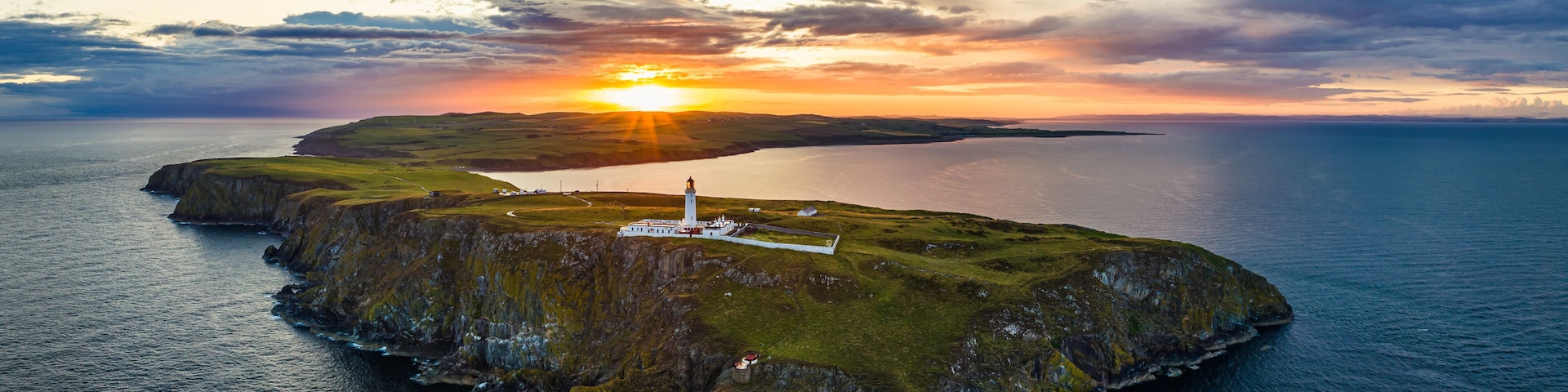 Sunset over Mull of Galloway Lighthouse from a drone, Mainland Scotland, UK