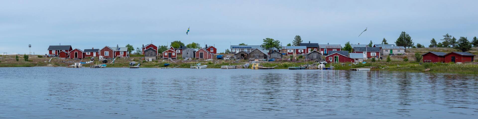 Traditional Fishing Village and Boat houses by the lake in Sweden on Stor-Rabben Island, Near Pitea in the Archipelago of Gulf of Bothnia in Northern Scandinavia.