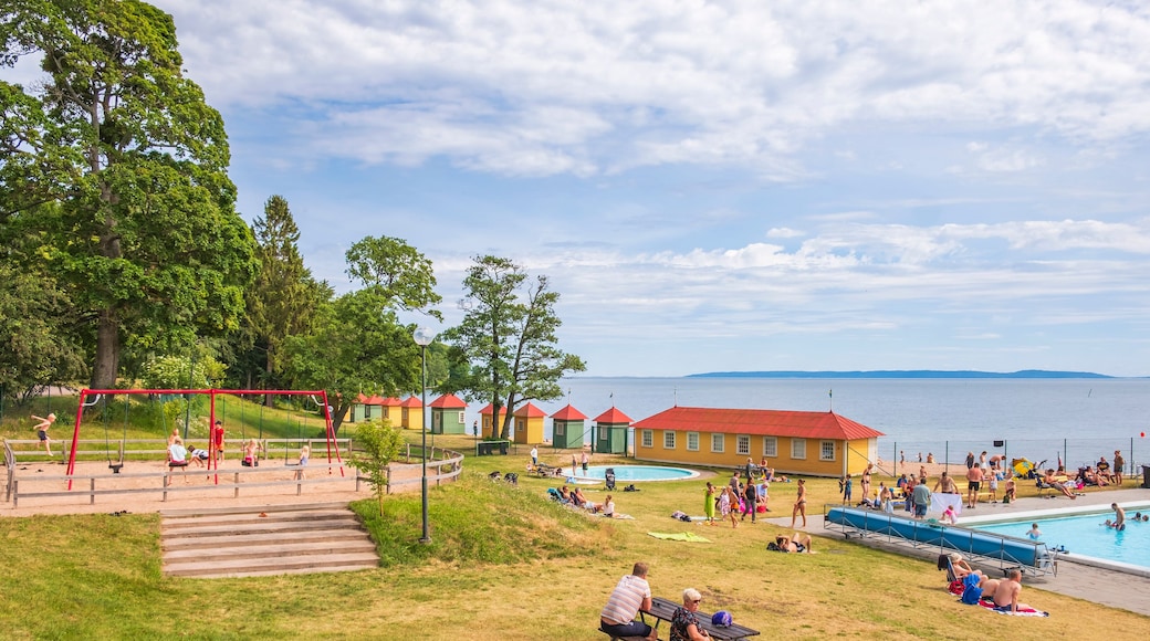 Bathing place with playing children at a playground