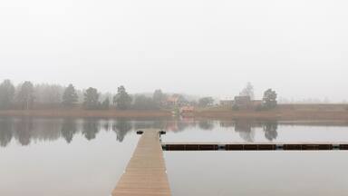 Pier on lake under clear sky