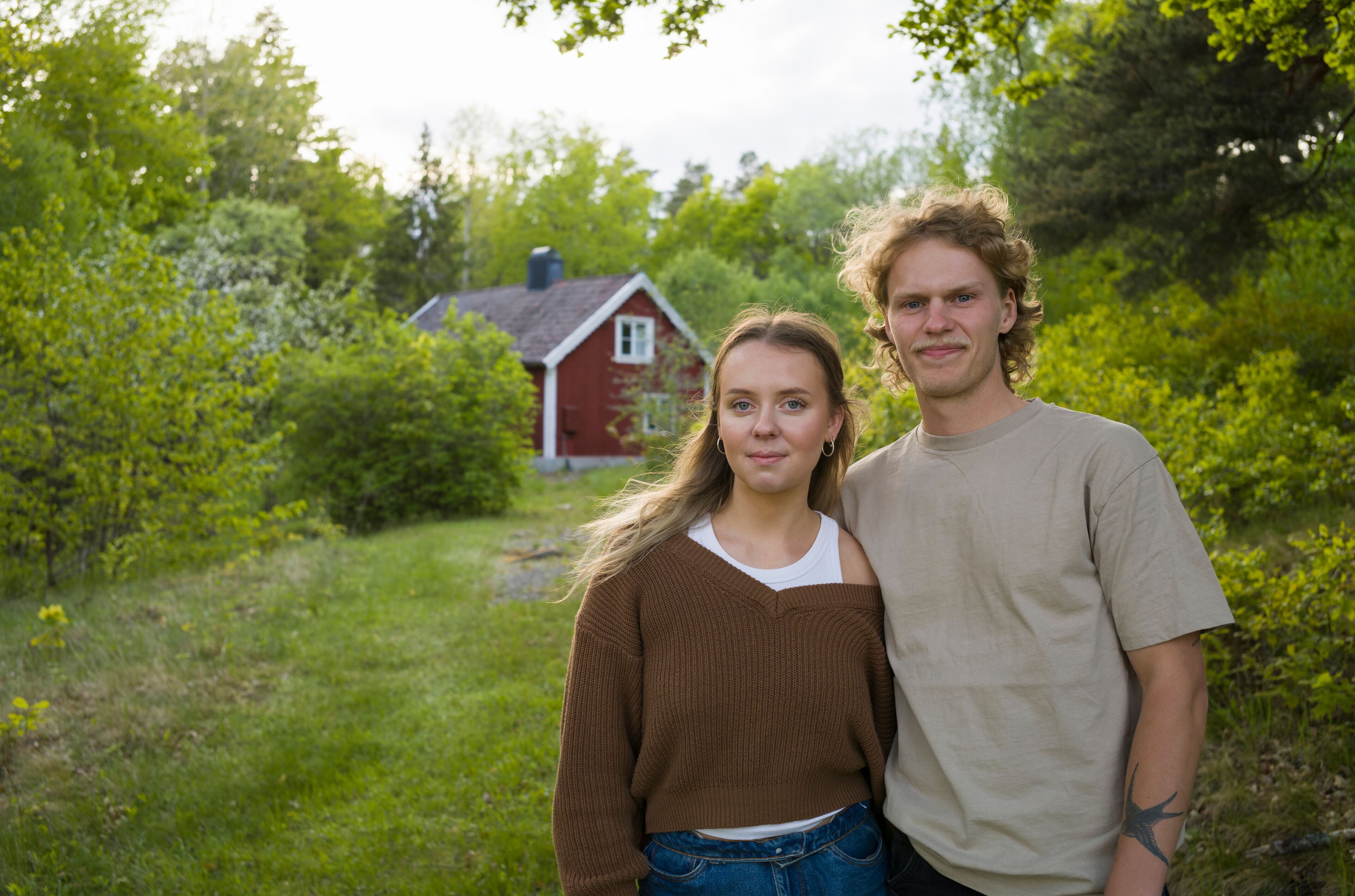 Portrait of young couple by house