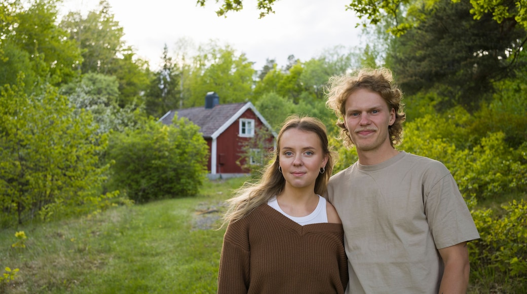 Portrait of young couple by house