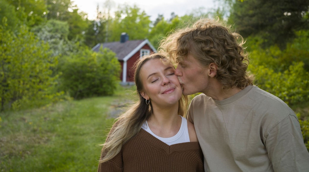 Young man kissing woman's cheek