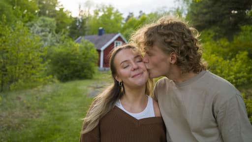 Young man kissing woman's cheek
