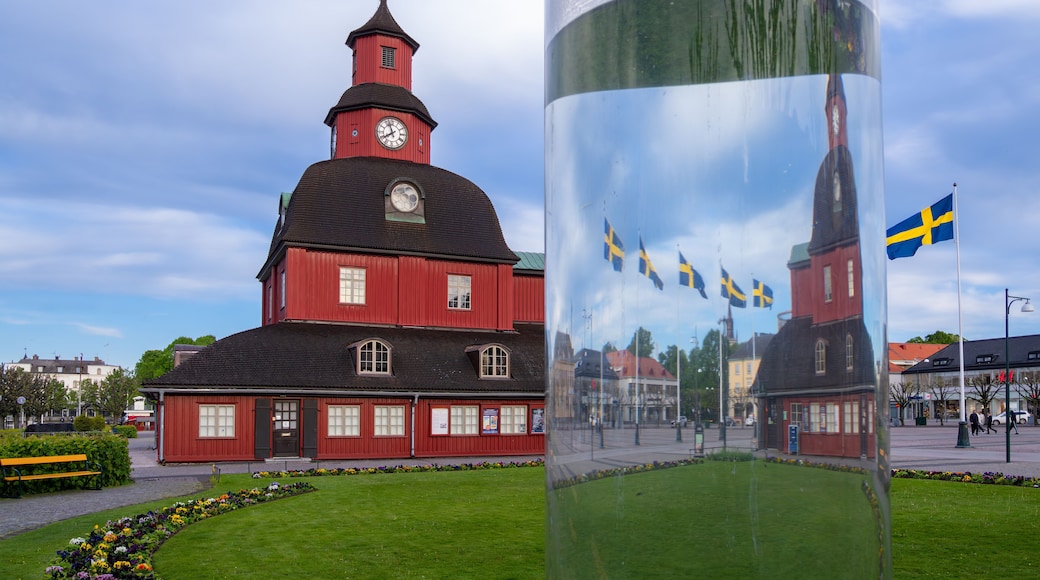 Lidkoping, Sweden - May 28, 2023: Historical red wooden town hall with waving swedish flags in Lidkoping.