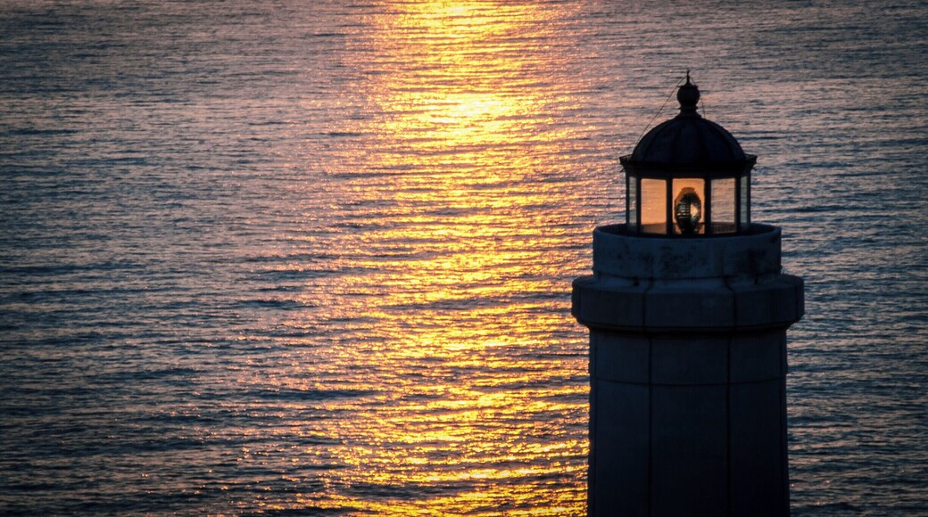 Sunrise at cape Palascìa. Cape Palascìa, commonly known as Capo d'Otranto, is Italy's most easterly point. It is situated in the territory of the Apulian city of Otranto, in the Province of Lecce at 40° 7' northing and 18° 31' easting.
The lighthouse there, recently renovated, is one of five Mediterranean lighthouses protected by the European Commission. It is often visited by tourists, especially at New Year, since it stands at the point where the dawn of the new year may first be seen in Italy.
According to nautical conventions, Capo d'Otranto marks the point where the Ionian Sea and the Adriatic Sea meet.