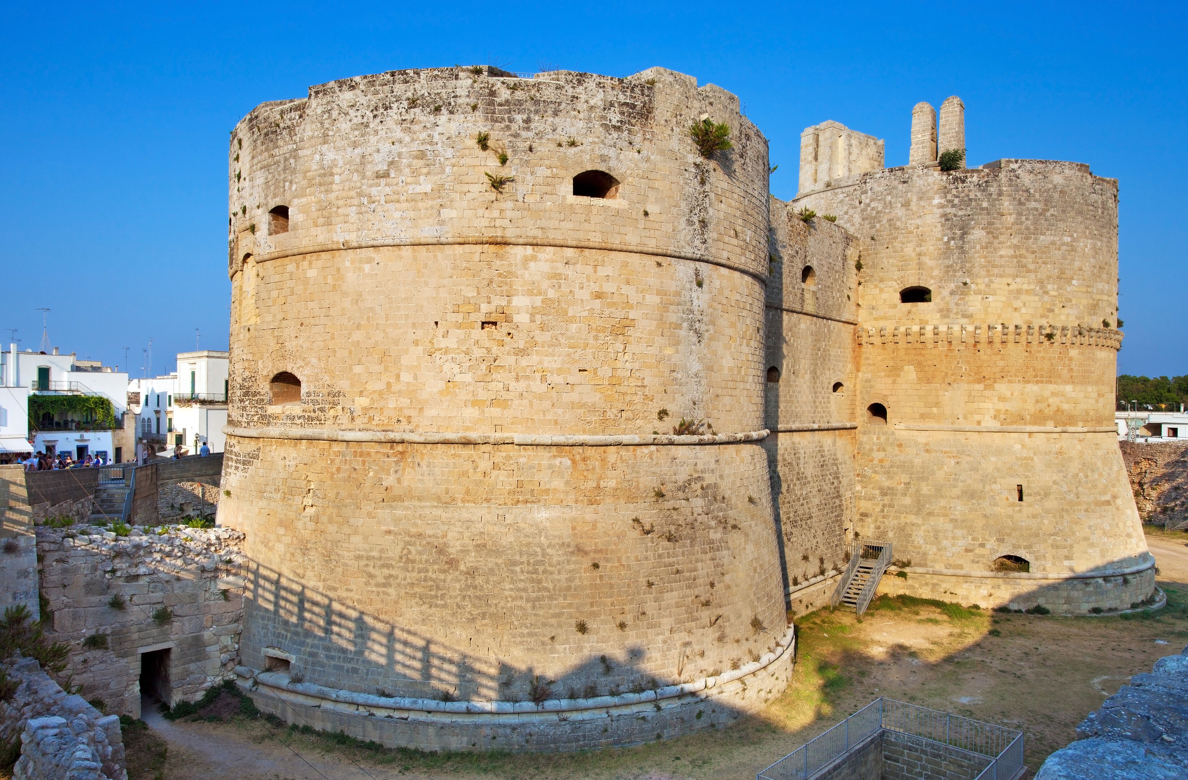A large, ancient stone fortress with multiple towers and a surrounding wall.