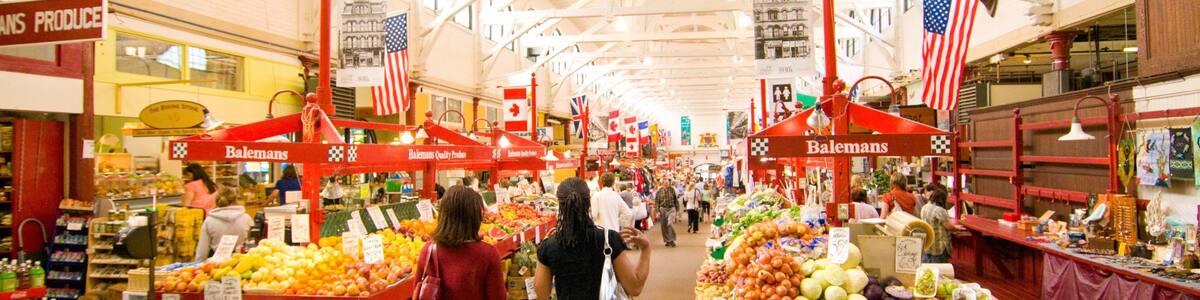 Saint John featuring markets and interior views as well as a small group of people