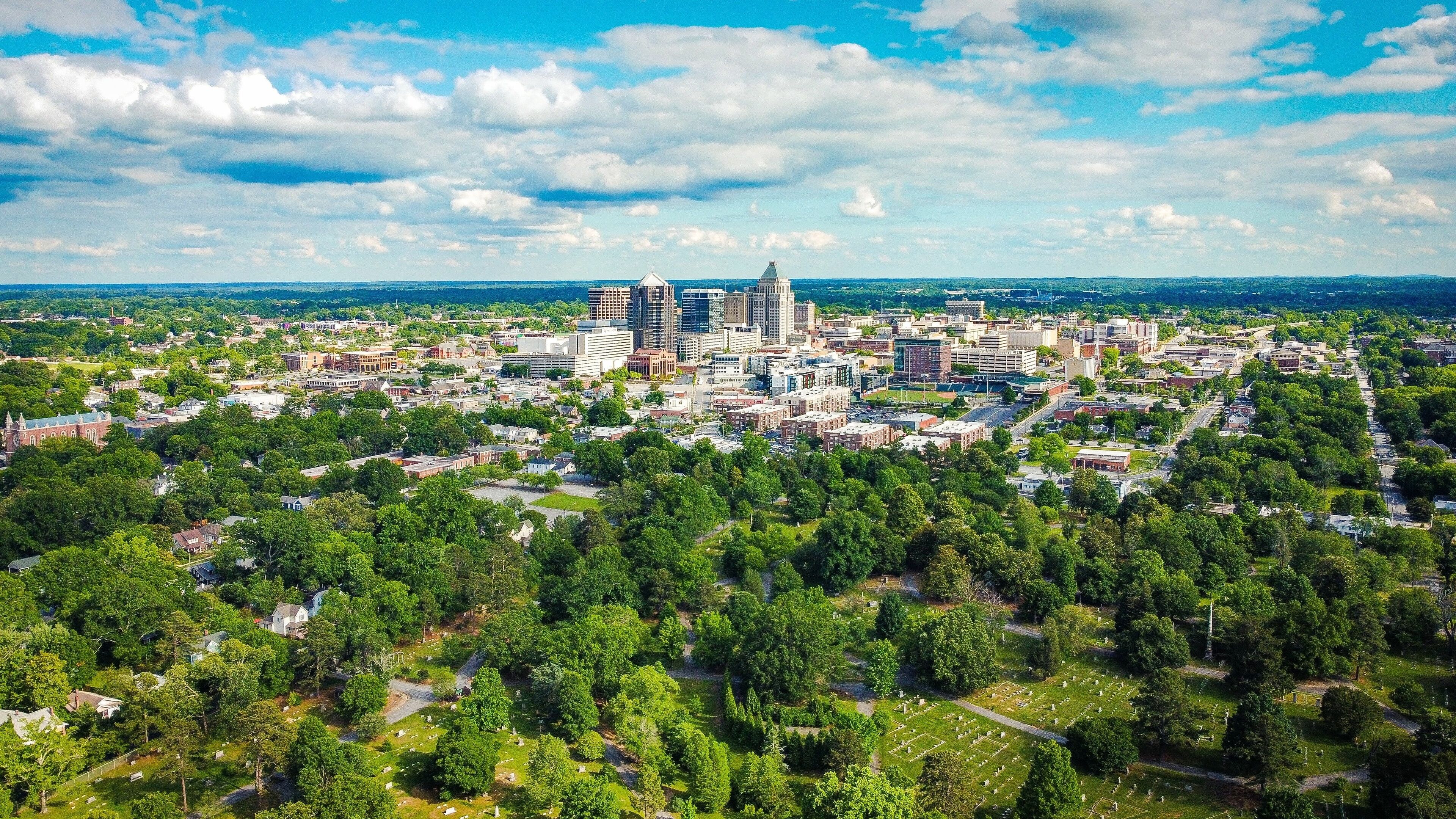 Aerial view of Greensboro city under a blue cloudy sky on a sunny day in summer