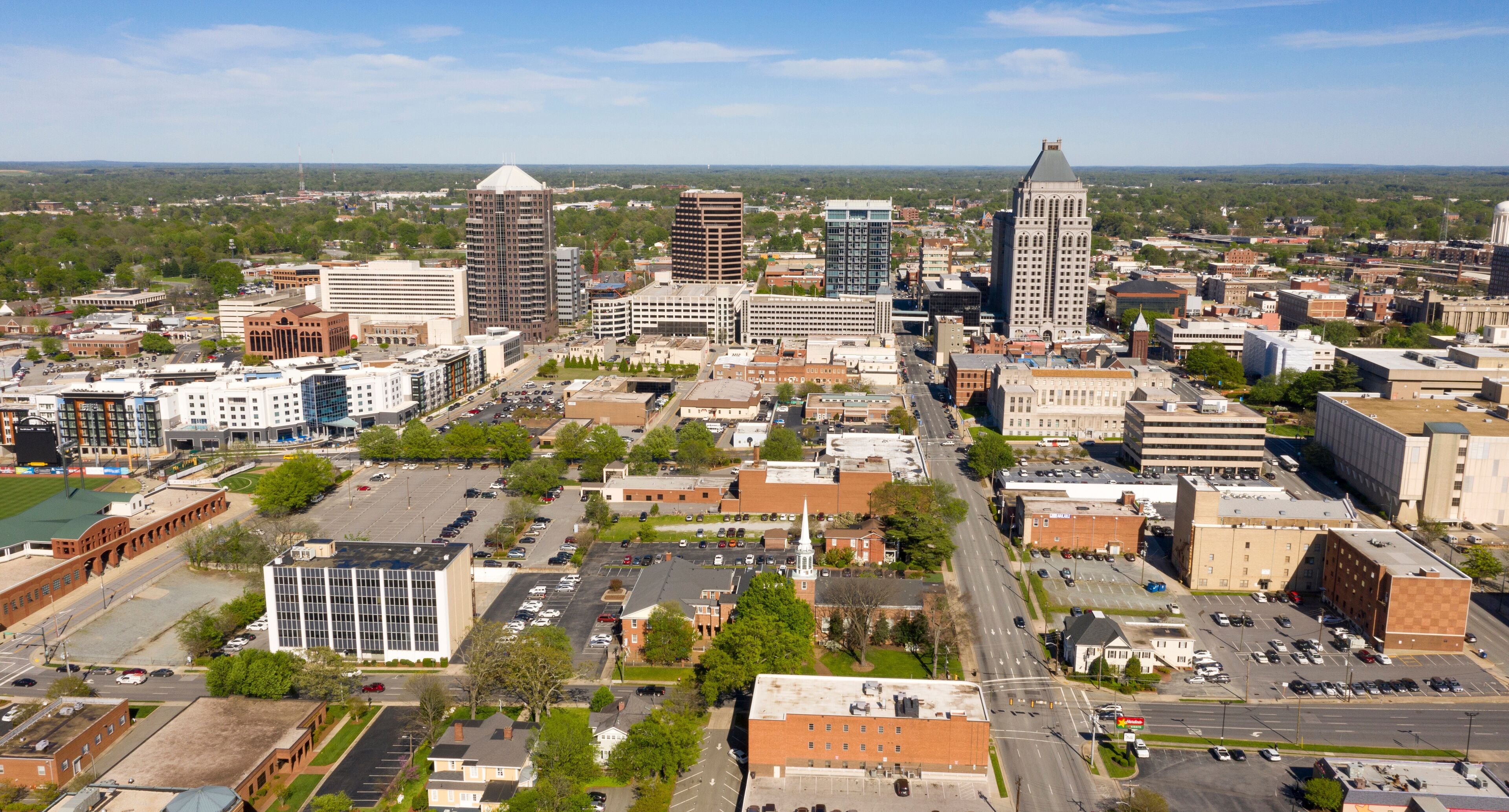 A cityscape with various buildings, roads, and green spaces.