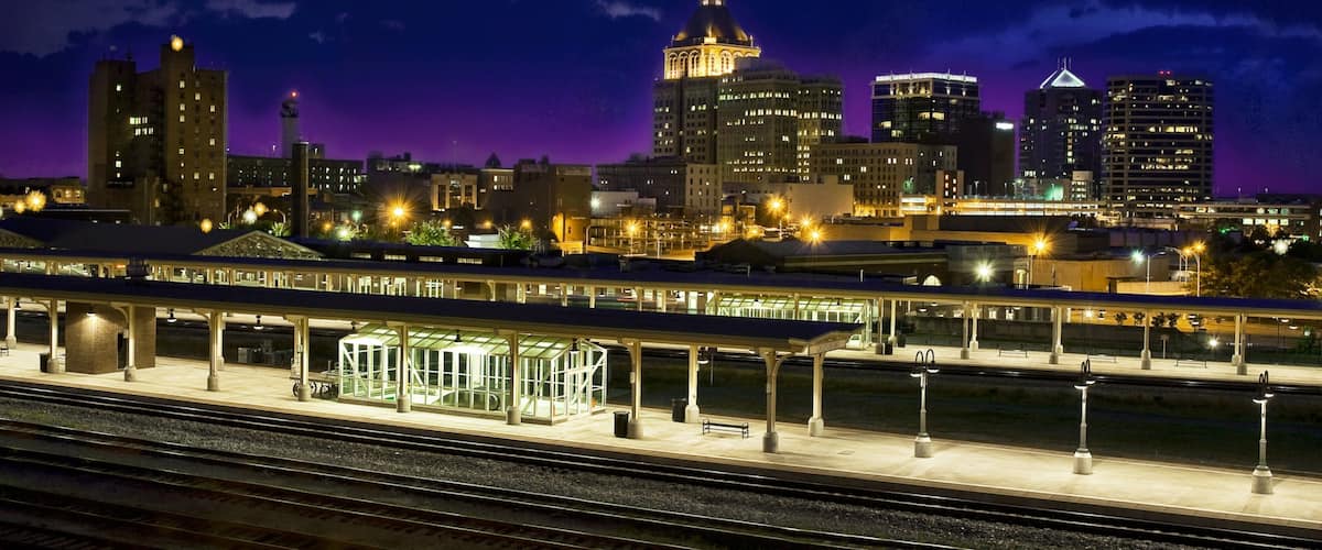 Greensboro showing night scenes, a high-rise building and railway items