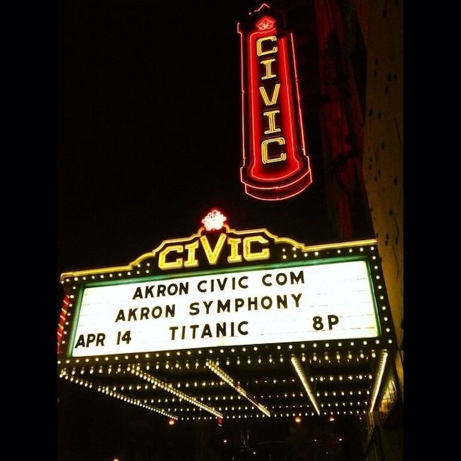 A theater marquee with the name 'CIVIC' and details about an event: 'AKRON CIVIC COM', 'AKRON SYMPHONY', 'APR 14', 'TITANIC', '8P'.