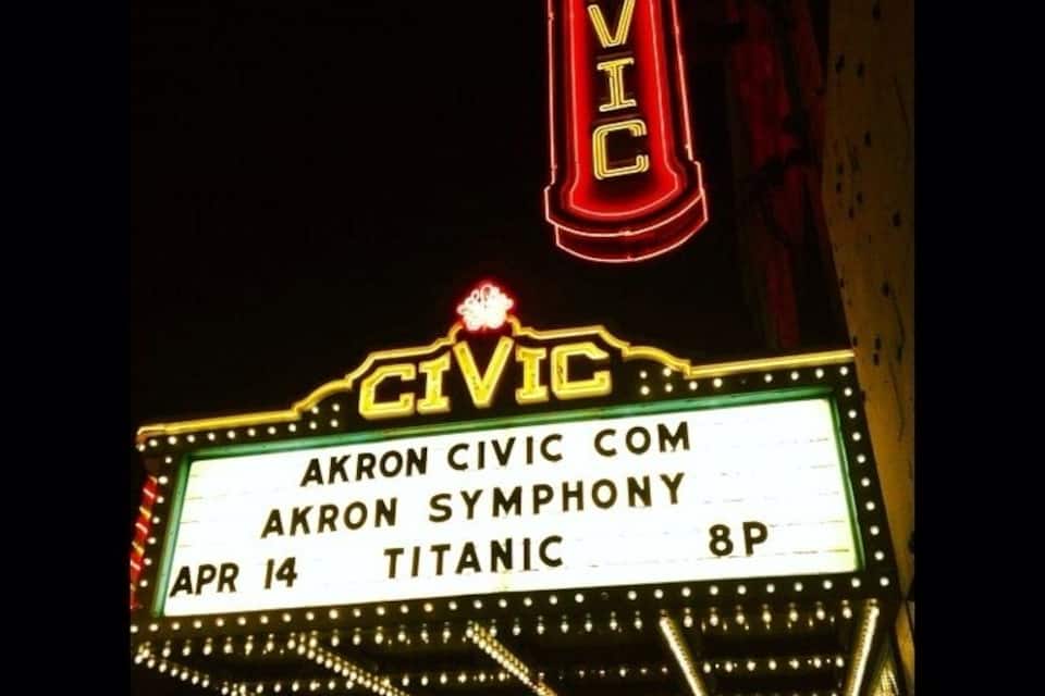 A theater marquee with the name 'CIVIC' and details about an event: 'AKRON CIVIC COM', 'AKRON SYMPHONY', 'APR 14', 'TITANIC', '8P'.
