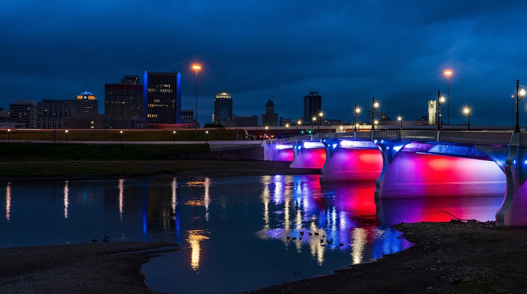 illuminated Red White and Blue 5th Street Bridge crosses Miami River at night into Dayton Ohio