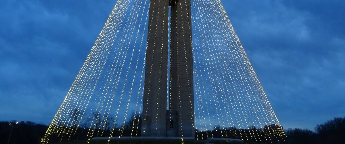 The Deeds Carillon illuminated for the holidays. An awesome spectacle and an awesomely short-lived road side attraction!
The Deeds Carillon, the largest carillon in Ohio had been transformed into the shape of a holiday tree towering 200 feet in the air and glowing with 20,000 white lights.
The plan was for the Carillon Tree of Light to be turned on nightly through New Year’s Day and be accompanied by the bells playing a medley of holiday classics on the hour.
I went on Sunday night and stood in wonderment of the melodic bells and the strands of light enhancing the already majestic silhouette of the carillon.
Overnight, wind gusts in excess of 40 or even 50 miles per hour damaged many of the strands of light. By morning, the damage was such that the display was beyond repair and will now be taken down for the year.
Quite a whirlwind tale for the inaugural lighting of the the Deeds Carillon.