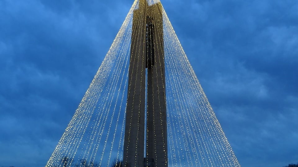 The Deeds Carillon illuminated for the holidays. An awesome spectacle and an awesomely short-lived road side attraction!
The Deeds Carillon, the largest carillon in Ohio had been transformed into the shape of a holiday tree towering 200 feet in the air and glowing with 20,000 white lights.
The plan was for the Carillon Tree of Light to be turned on nightly through New Year’s Day and be accompanied by the bells playing a medley of holiday classics on the hour.
I went on Sunday night and stood in wonderment of the melodic bells and the strands of light enhancing the already majestic silhouette of the carillon.
Overnight, wind gusts in excess of 40 or even 50 miles per hour damaged many of the strands of light. By morning, the damage was such that the display was beyond repair and will now be taken down for the year.
Quite a whirlwind tale for the inaugural lighting of the the Deeds Carillon.