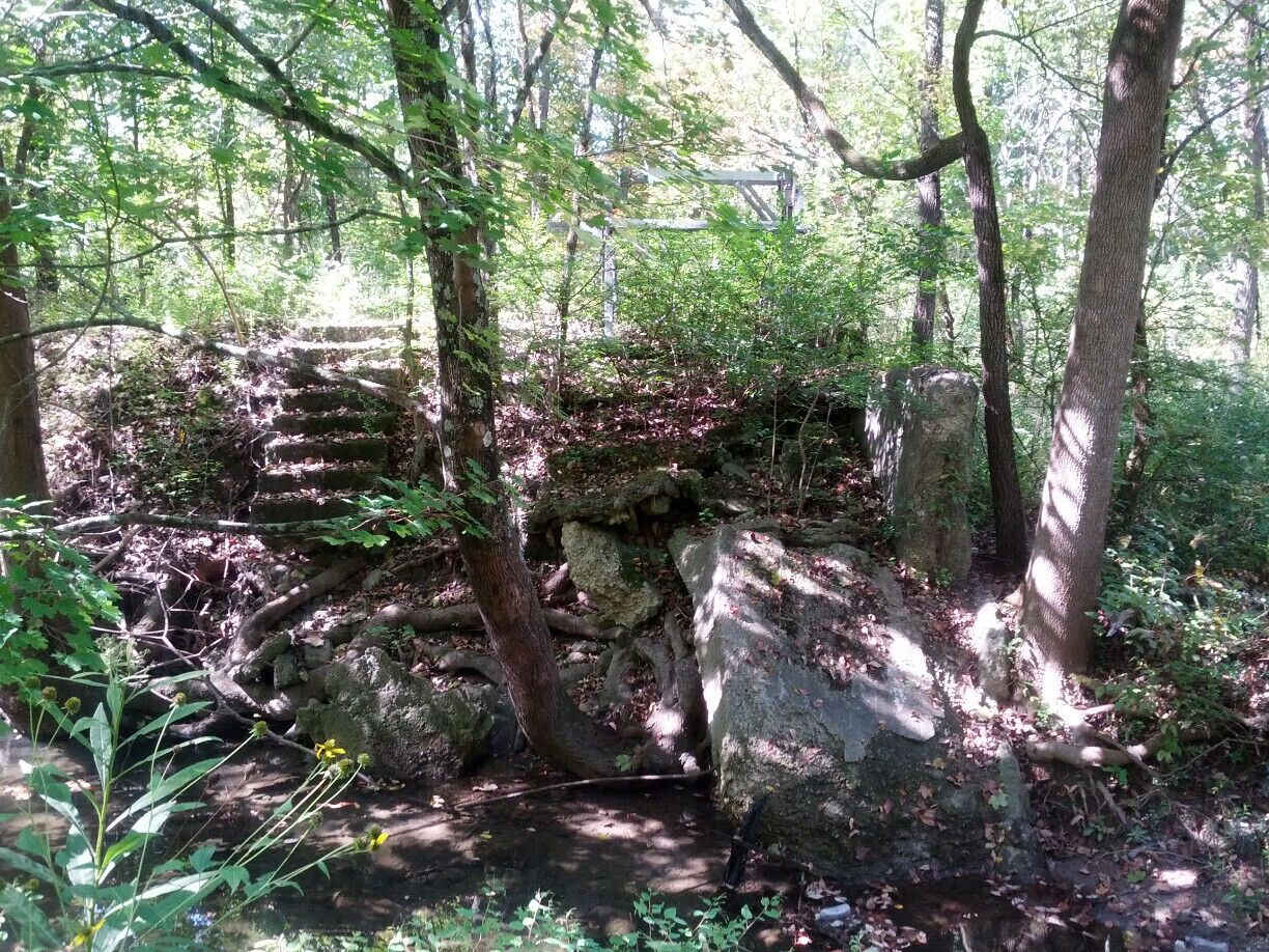 Before becoming Possum Creek MetroPark, this land was an outdoor recreation area called Argonne Forest, operating from the 1920's to the 1940's. Here are the remains of the swimming pool steps and diving platform. The pool was constructed by building retaining walls and a spillway to collect the waters of Possum Creek. 