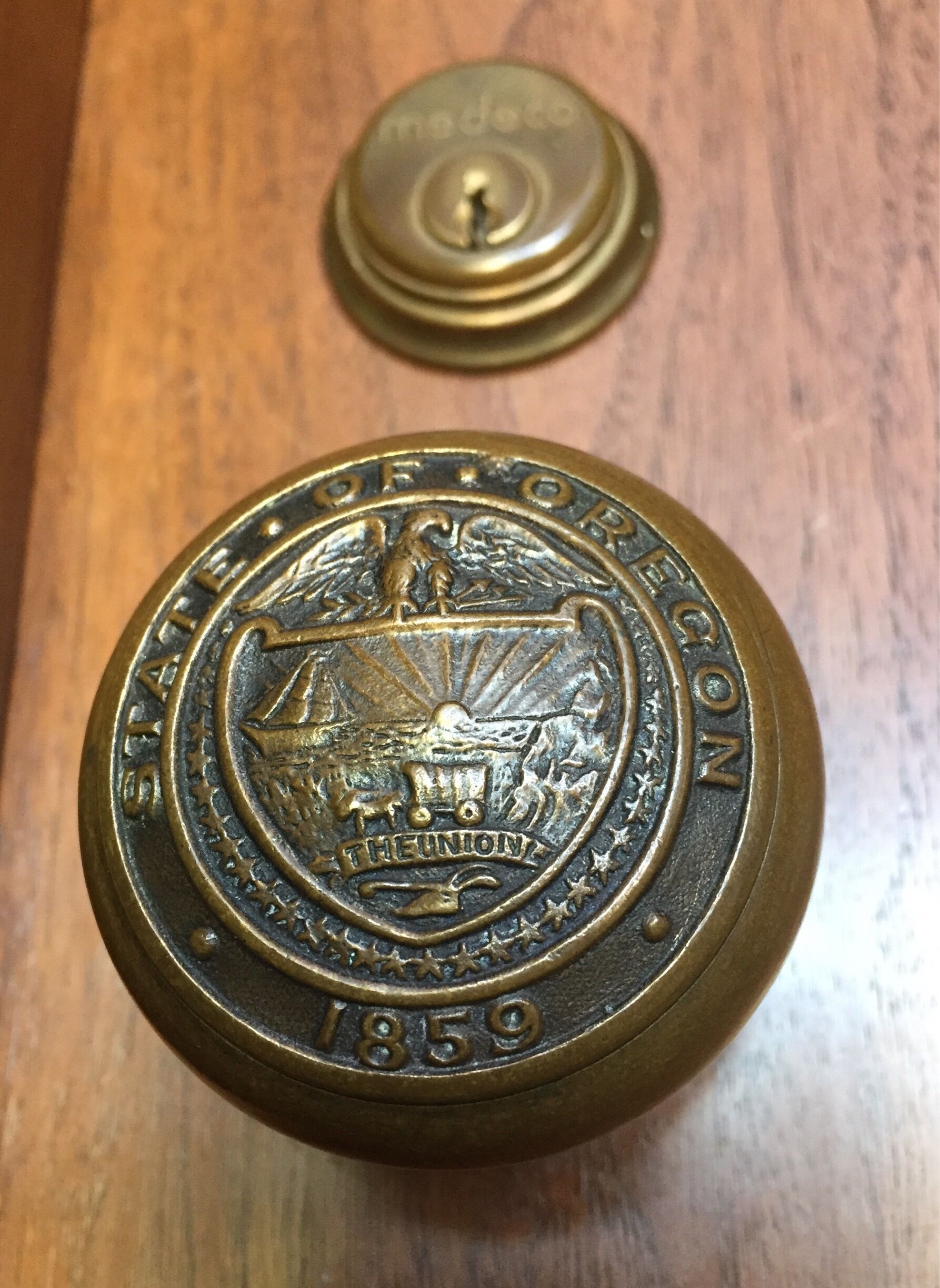 Official Oregon state sealed knobs adorn the wooden doors of its state Capitol.  