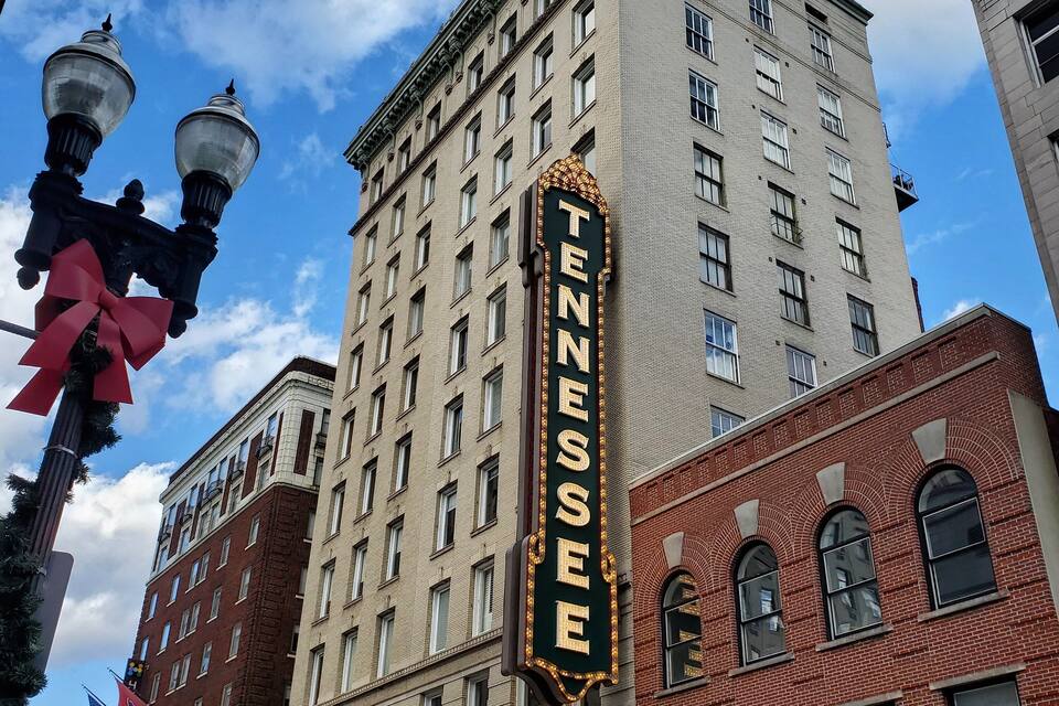 A theater with a marquee reading "Tennessee" and a sign for "The Tennessee Theatre."