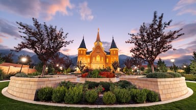 A church with two towers, surrounded by landscaped gardens and trees.