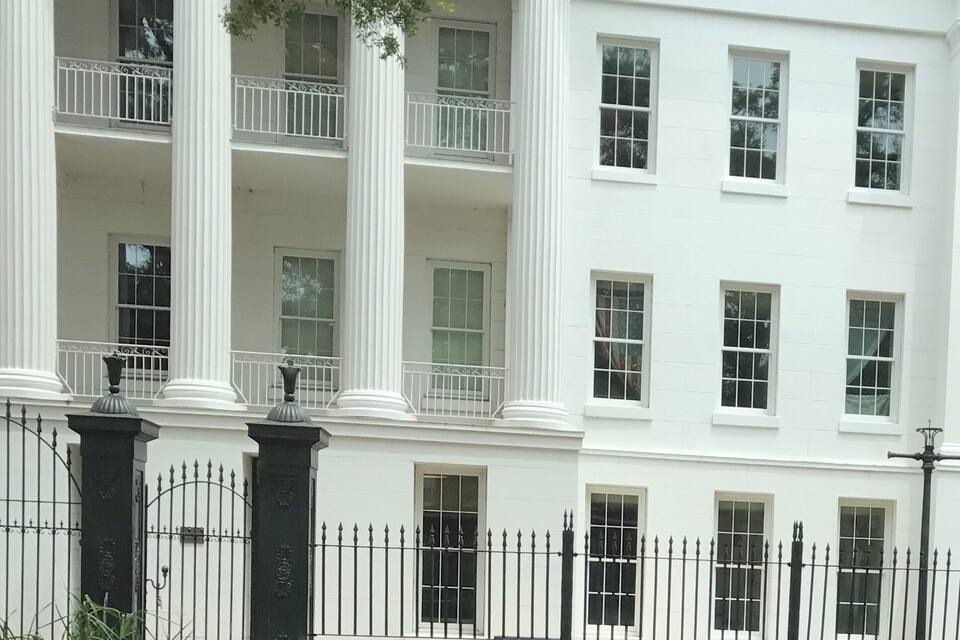 A white building with columns and balconies.