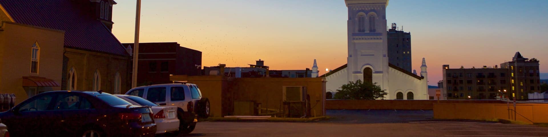 Huntsville which includes a church or cathedral and a sunset