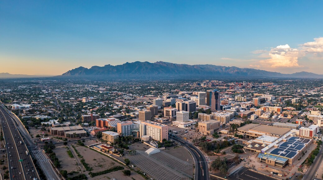 A cityscape with a prominent mountain range in the background.