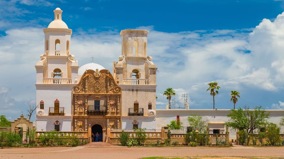 A historic building with two towers and a large central archway.