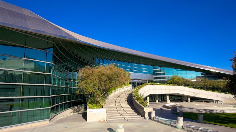 A modern building with a glass facade and a curved entrance.