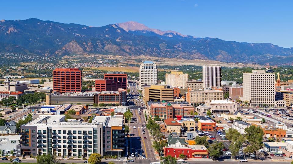 A cityscape with a mountain range in the background.