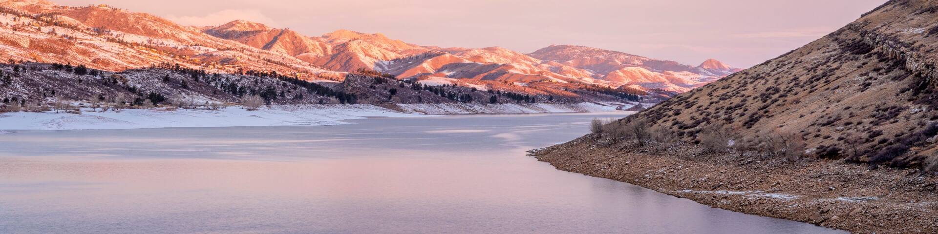 A frozen river with mountains in the background.
