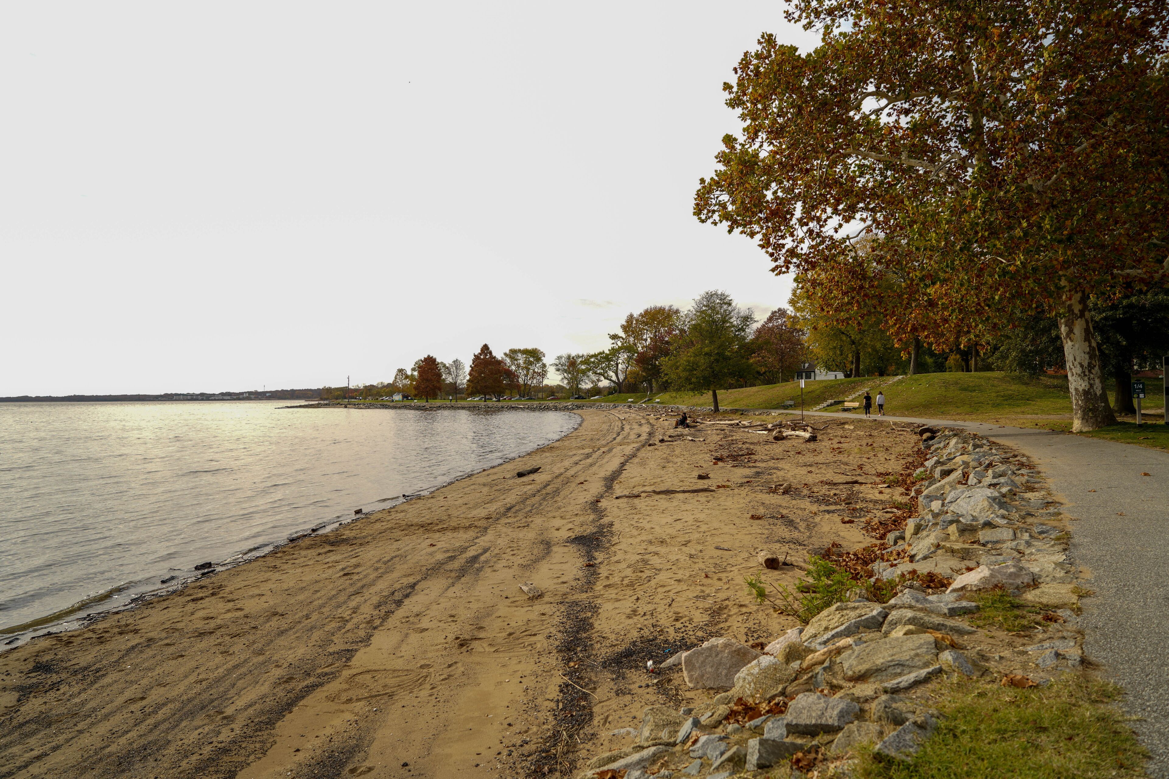 Beautiful view of a small road next to the beach with many rocks in Dover, Delaware