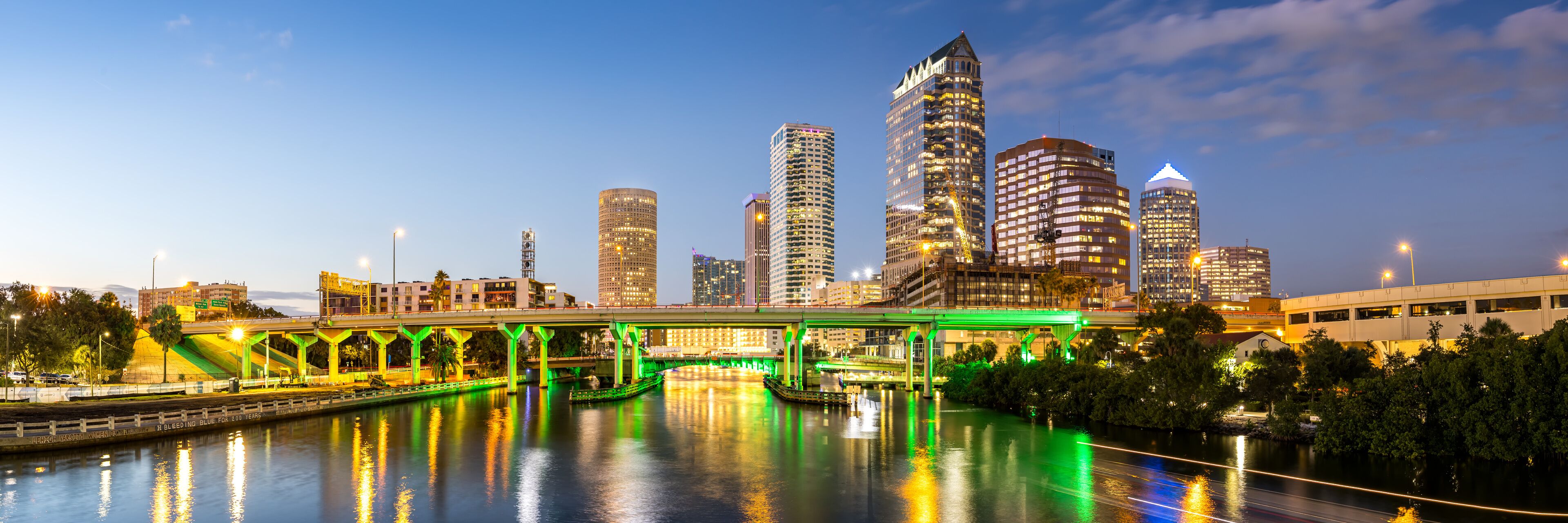 Tampa skyline with skyscrapers real estate bridge over Hillsborough River panorama at night in downtown Tampa, United States