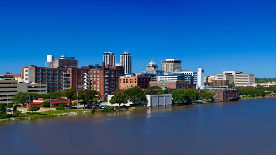 A city skyline with a river in the foreground.
