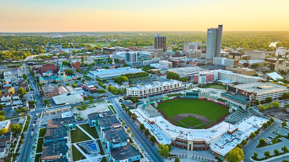 Sunrise glow over Parkview Field Stadium Fort Wayne IN skyscrapers downtown aerial