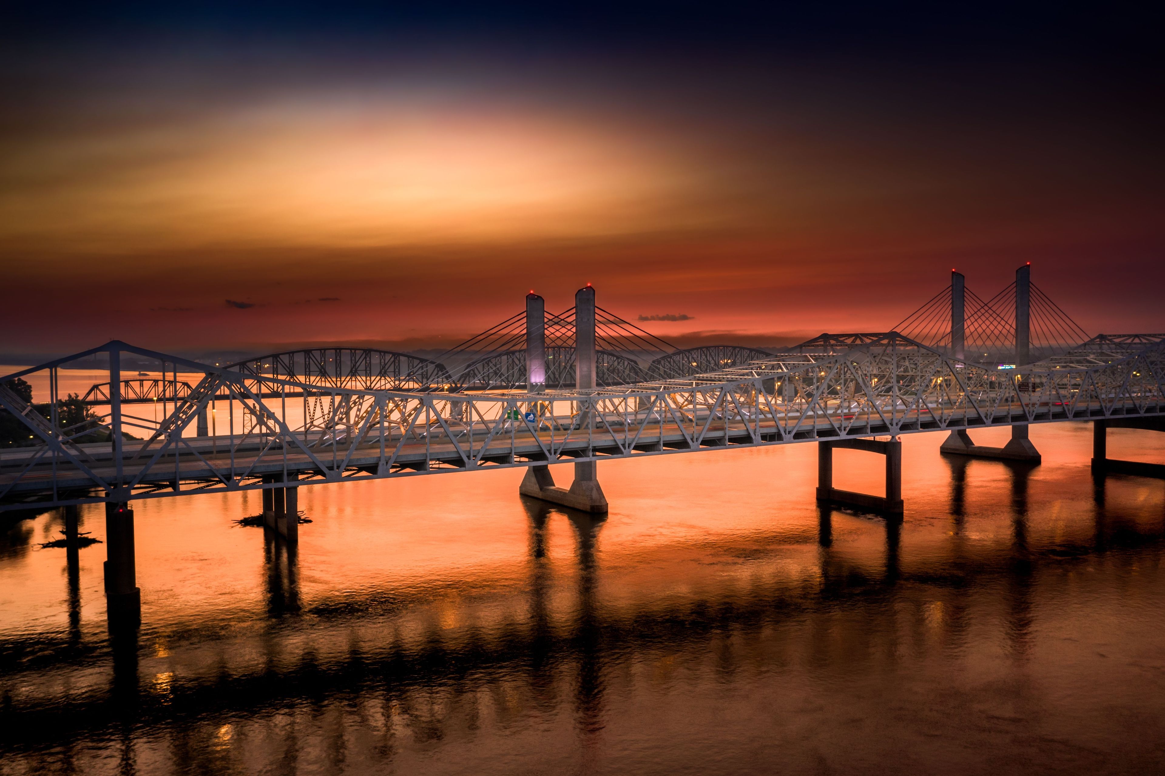 Drone view of the Abraham Lincoln Bridge over Ohio River during sunset in Louisville, Kentucky, USA