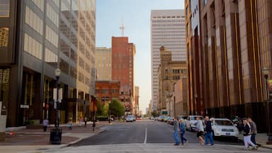 Louisville which includes a city and street scenes as well as a small group of people