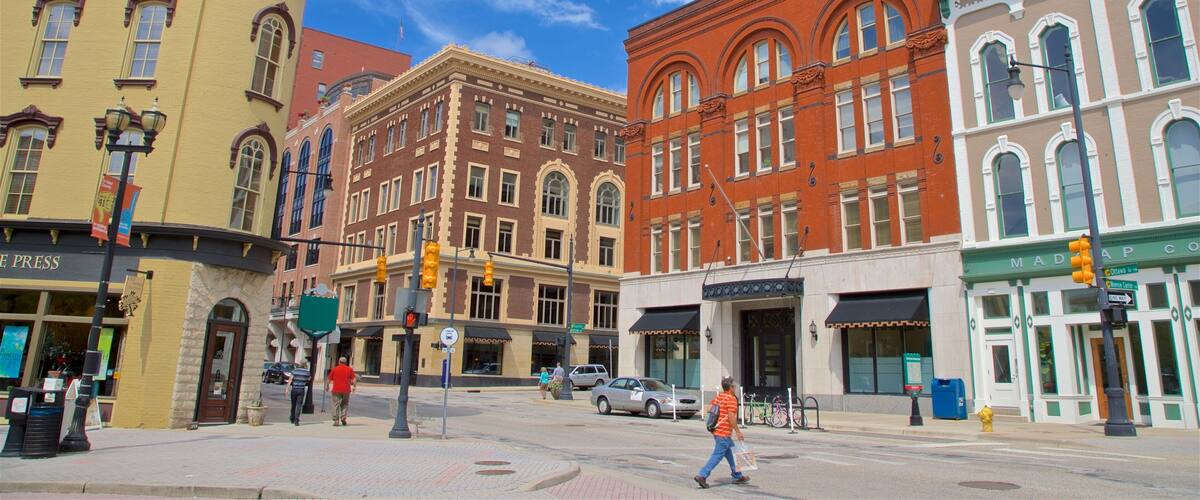 A street with historic buildings, a pedestrian crossing, and a traffic light.