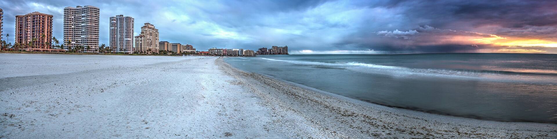 Sunset and clouds over the calm water of Tigertail Beach on Marco Island