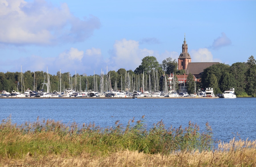 View across the picturesque Lake Vattern, towards Askersund church and marina in Orebro County in Sweden. Sunny summers day, with blue sky. Copy space.