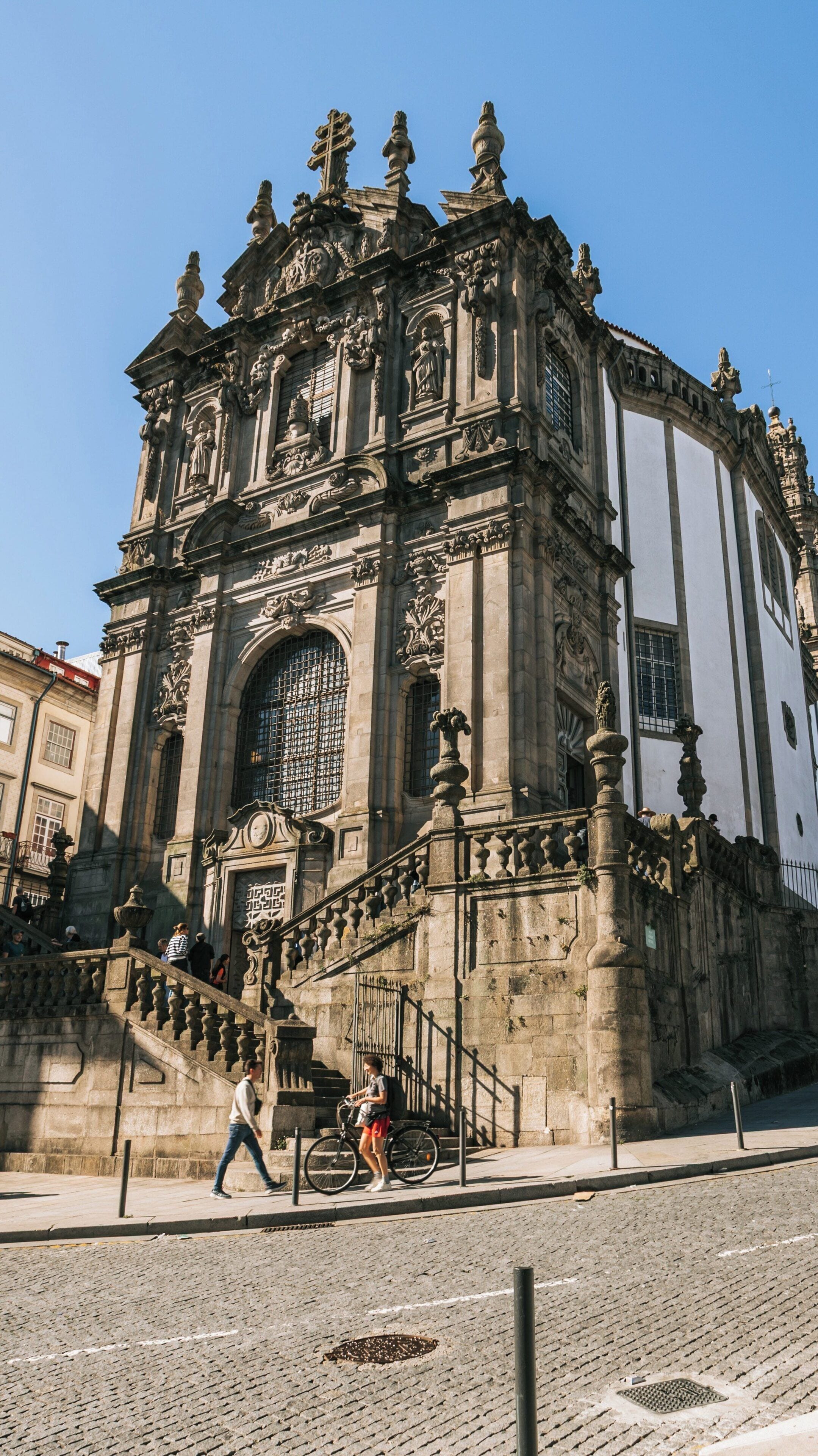Clerigos Church in Miragaia district showcases stunning architecture under a clear blue sky in Porto, Portugal