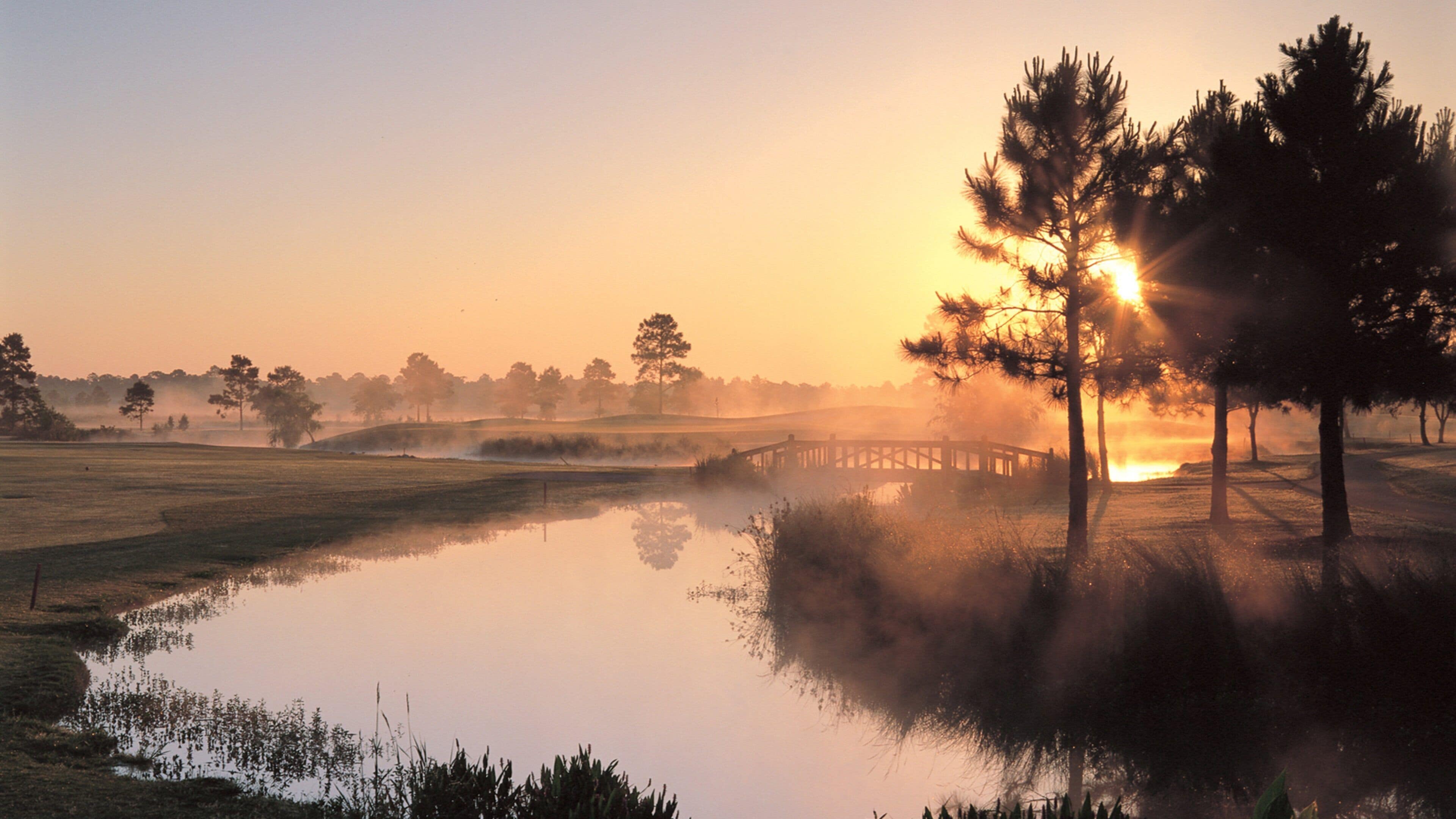 Gulf Shores which includes mist or fog, a sunset and a river or creek