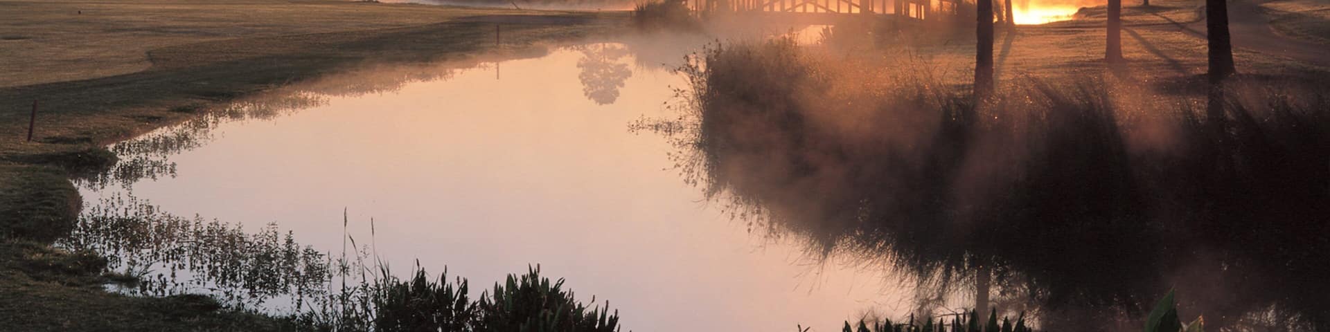 Gulf Shores which includes mist or fog, a sunset and a river or creek
