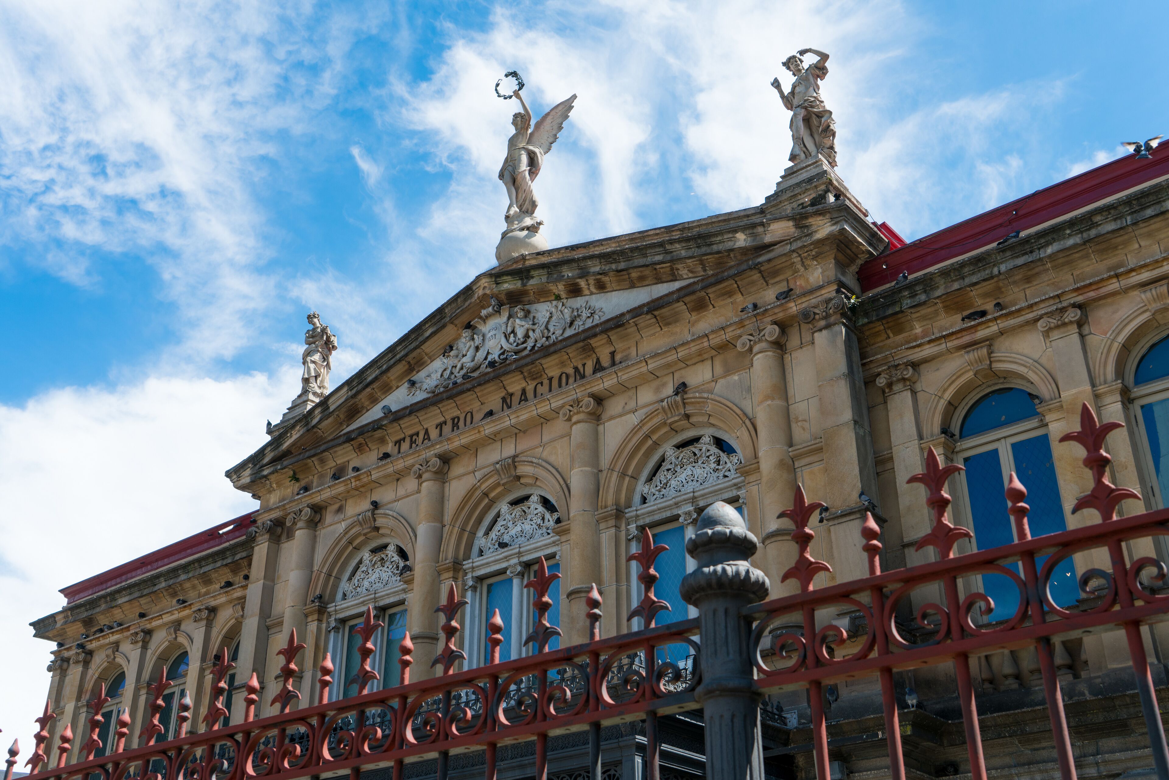 View of the gable roof of National Theater in Costa Rica downtown square with angle, beautiful blue sky and copy space for text.